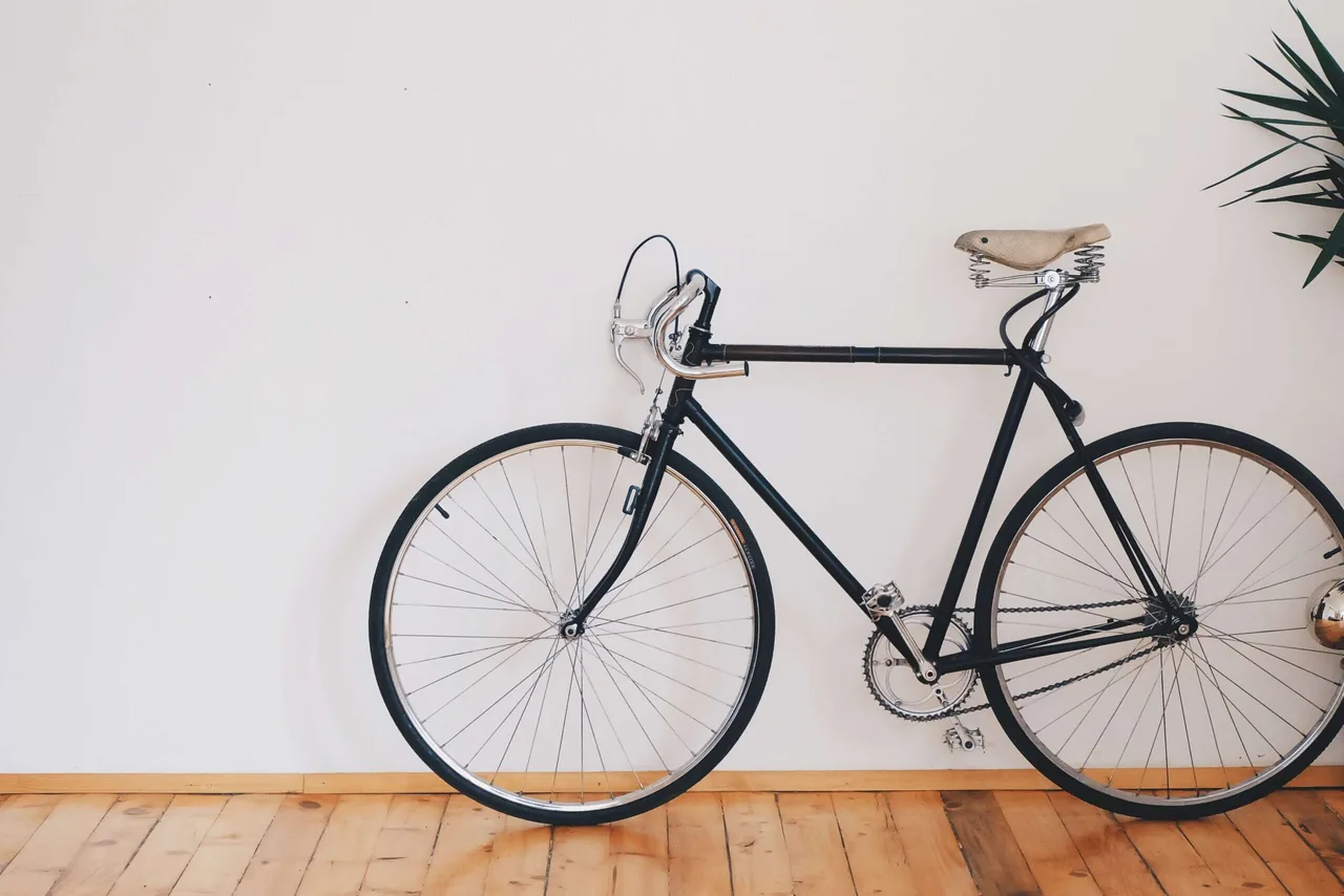 A vintage bicycle against a bare wall